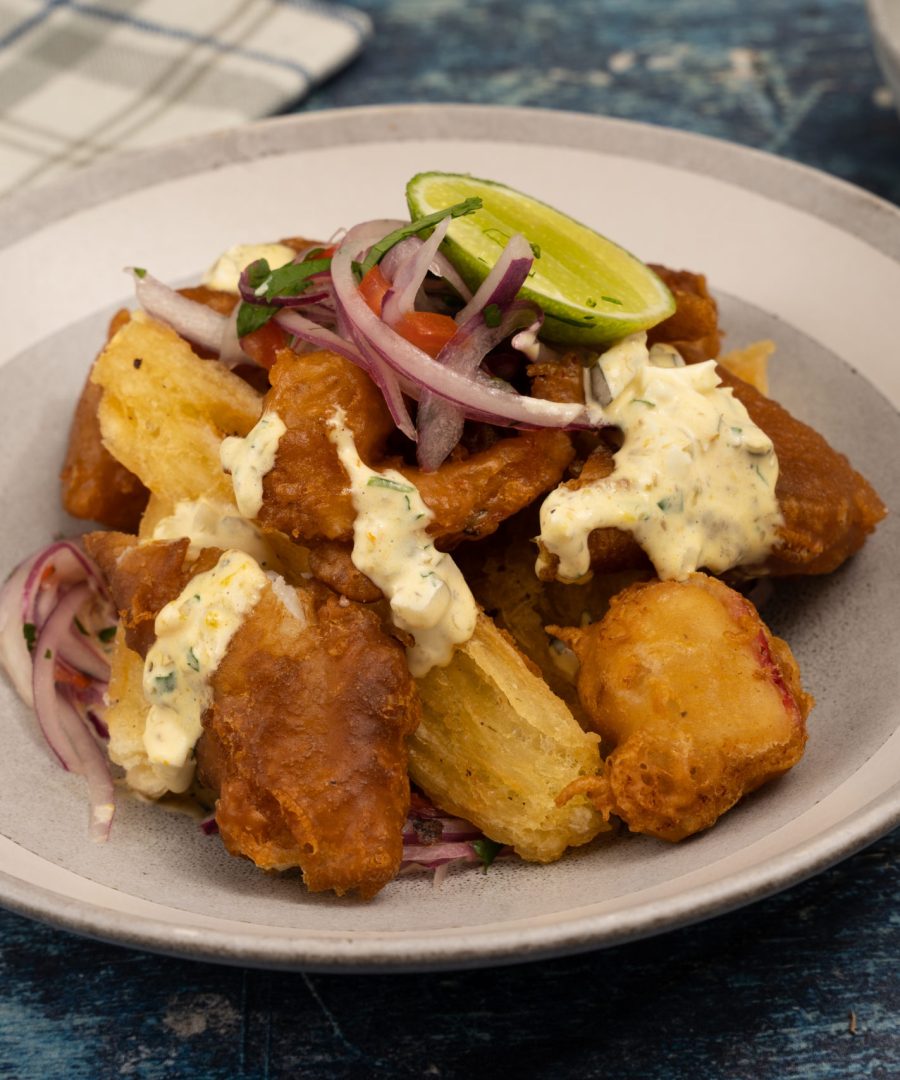 jalea mixta peruana con sarza criolla y yuca frita - peruvian jalea mixta fried seafood with sarza criolla and yucca"