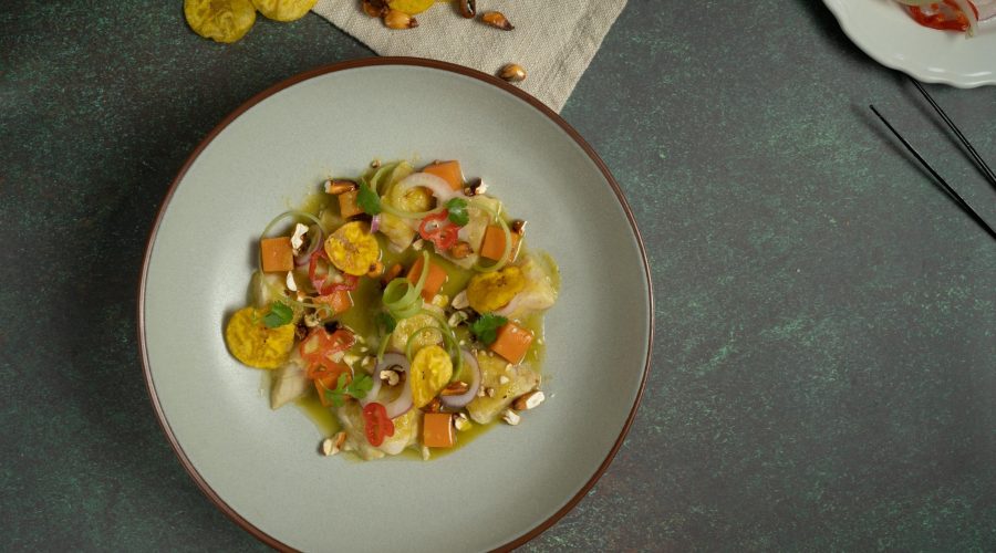 Peruvian ceviche with citrus aji marinade canchita and sweet potato in white bowl - ceviche peruano con marinada citrica canchita y camote en tazón blanco