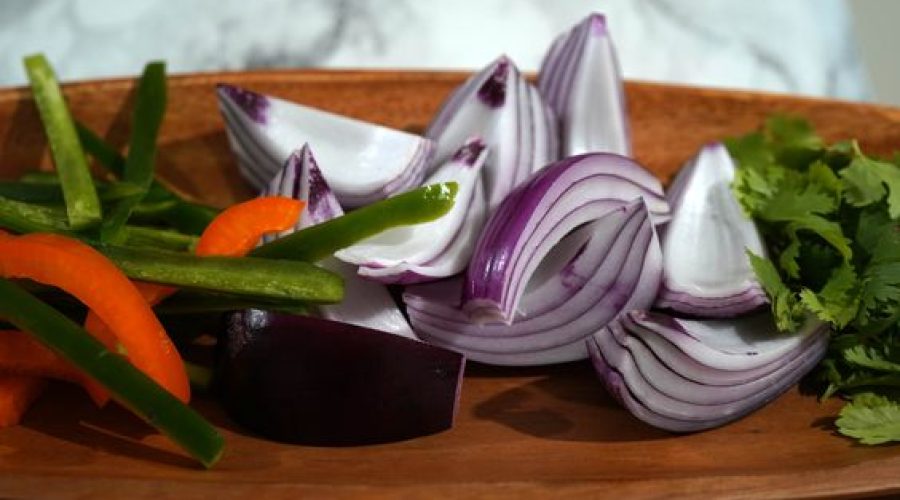 a pic of onions, peppers and cilantro on a plate for escabeche de pescado