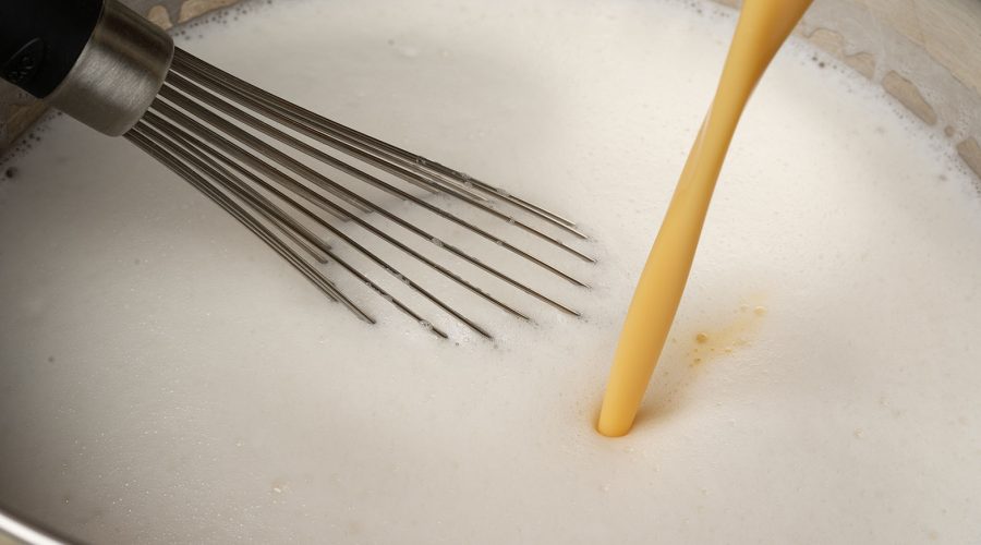 eggs and link added to a bowl, ingredients for leche asada