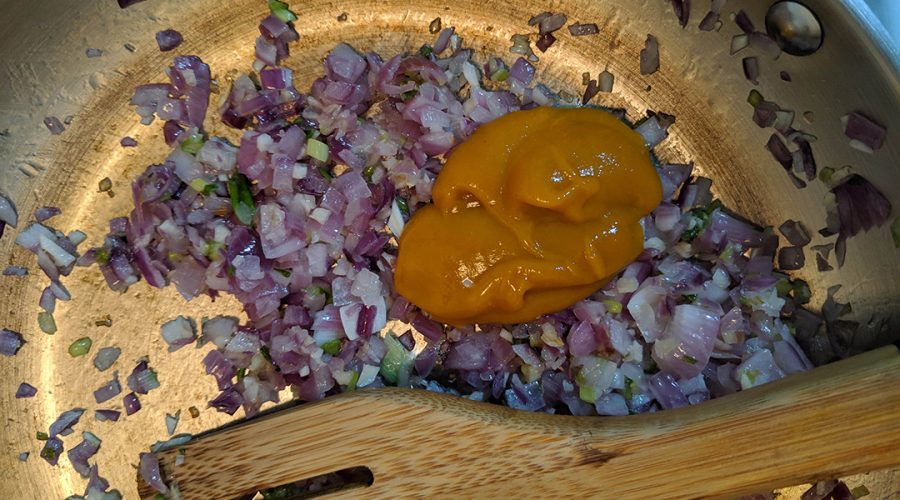 "aderezo de cebolla ajo y aji amarillo cocinandose para tacu tacu - sofrito of onion garlic and aji amarillo cooking for tacu tacu
