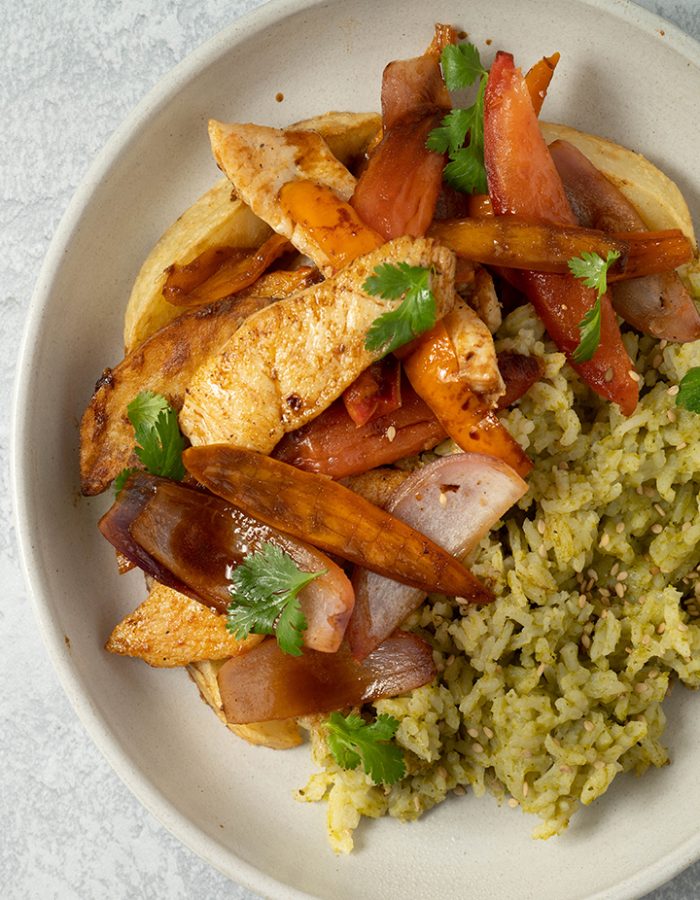 pollo saltado servido en plato con arroz y papas fritas - pollo saltado served on a plate with rice and french fries