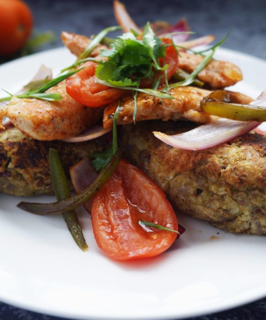 tacu tacu de lentejas peruano dorado en sarten servido con salsa criolla - Peruvian lentil tacu tacu golden in a pan served with salsa criolla