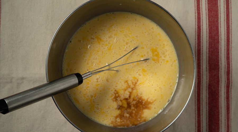 mezcla de crema volteada siendo colada para textura suave - crema volteada batter being strained for smooth texture