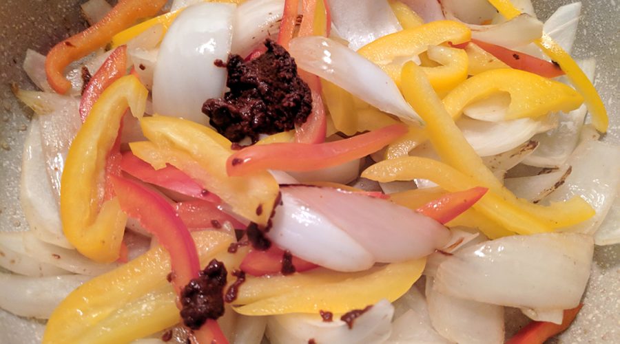 a pic of peppers, onions being cooked